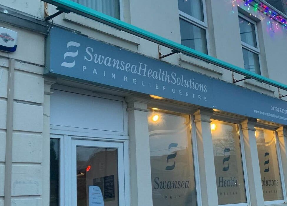 Exterior of Swansea Health Solutions, a wellness venue in Gowerton, Wales, GB showcasing storefront lighting.