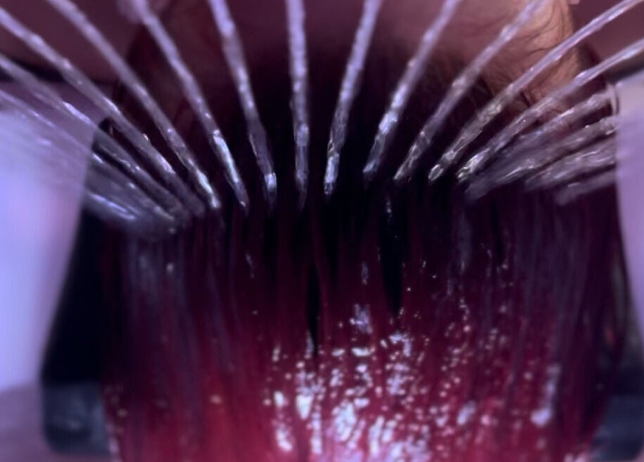 Luxurious hair wash at Heaven On T'hill, Todmorden, England, GB showcasing flowing water on vibrant hair.