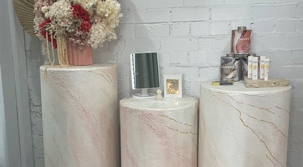 Elegant display of skincare products and flowers at VitalSkin Aesthetics, Annandale, New South Wales, AU.