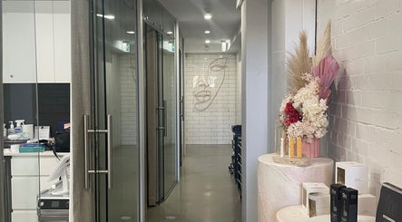 Modern hallway at VitalSkin Aesthetics in Annandale, New South Wales, AU, with floral display and sleek decor.