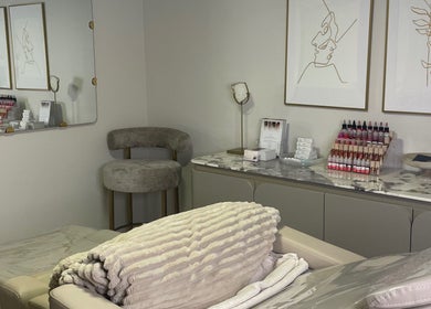 Cozy treatment room at Vital Skin Aesthetics, Birchgrove, New South Wales, AU featuring plush chairs and skincare products.