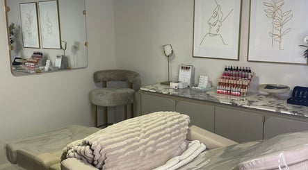 Cozy treatment room at Vital Skin Aesthetics, Birchgrove, New South Wales, AU featuring plush chairs and skincare products.