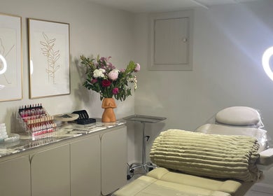 Elegant treatment room at Vital Skin Aesthetics, Birchgrove, New South Wales, AU with chic decor and flowers.