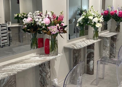Elegant flower arrangements on marble vanities at Vital Skin Aesthetics, Birchgrove, New South Wales, AU.