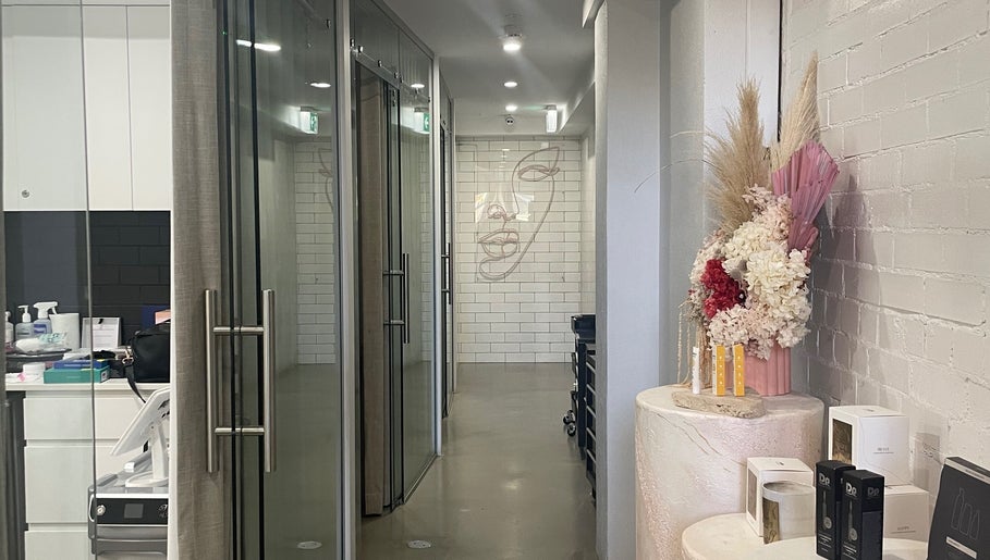 Elegant hallway at Vital Skin Aesthetics, Annandale, New South Wales showcasing floral decor and modern design.