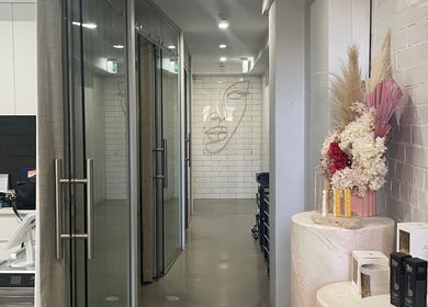 Elegant hallway at Vital Skin Aesthetics, Annandale, New South Wales showcasing floral decor and modern design.