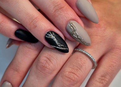 Artistic nail design at Anne's Nails & Toes in Pretoria, Gauteng, ZA. Elegant black and grey nails with silver accents.