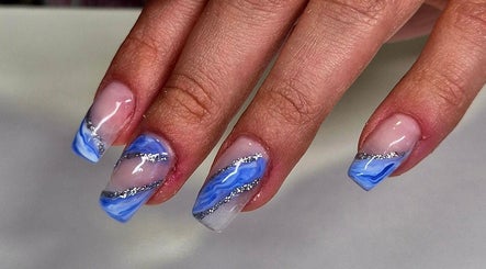 Elegant blue marbled nails with silver accents at Anne's Nails & Toes, Pretoria, Gauteng, ZA.