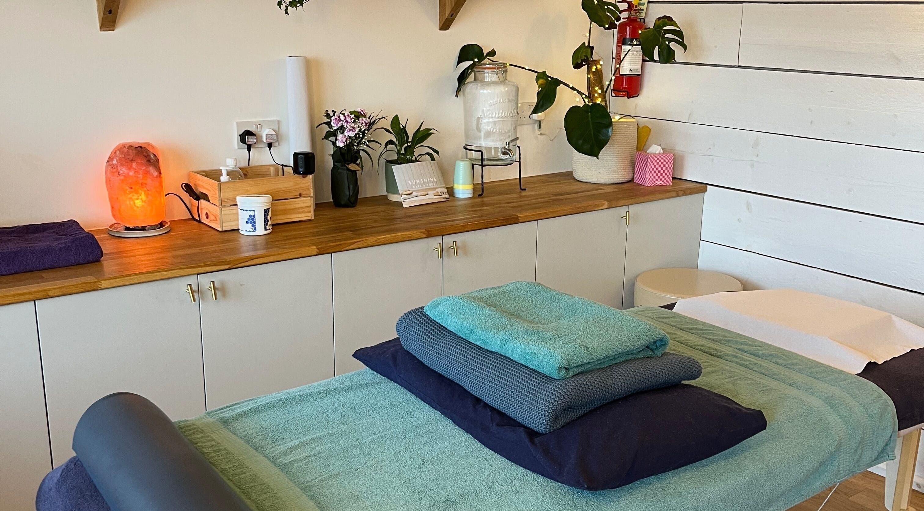 Ria Sands wellness room in Penryn, England, GB, featuring a massage table and calming decor.