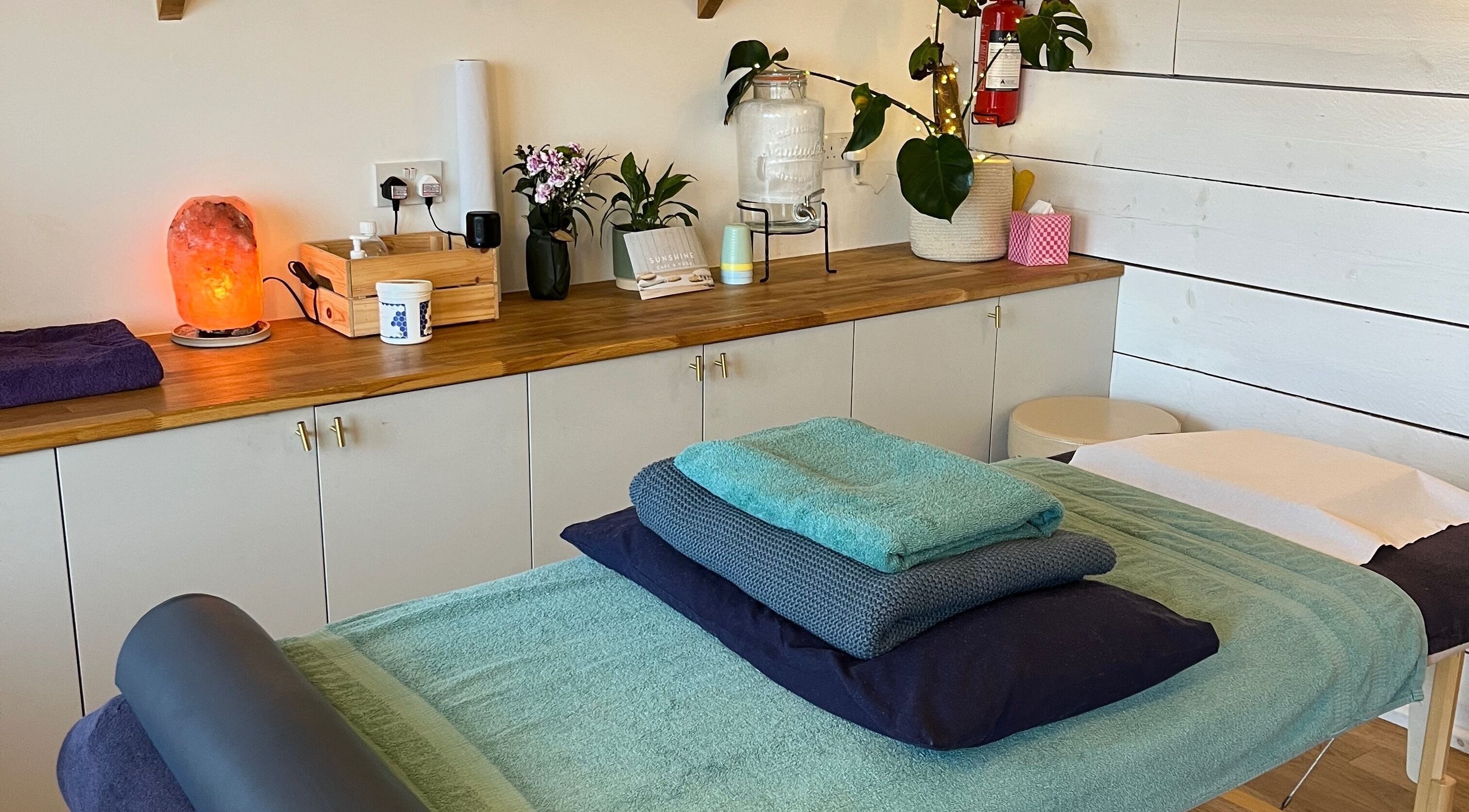 Relaxing massage room at Ria Sands, Penryn, England, GB with soft towels and Himalayan salt lamp.