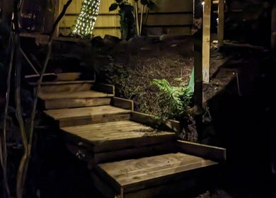 Illuminated garden steps at Sakura Wellness Institute, Audley, England, GB, create a peaceful ambiance.
