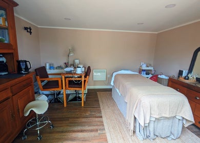 Sakura Wellness Institute's serene spa room in Audley, England, GB, featuring a massage table and calming decor.