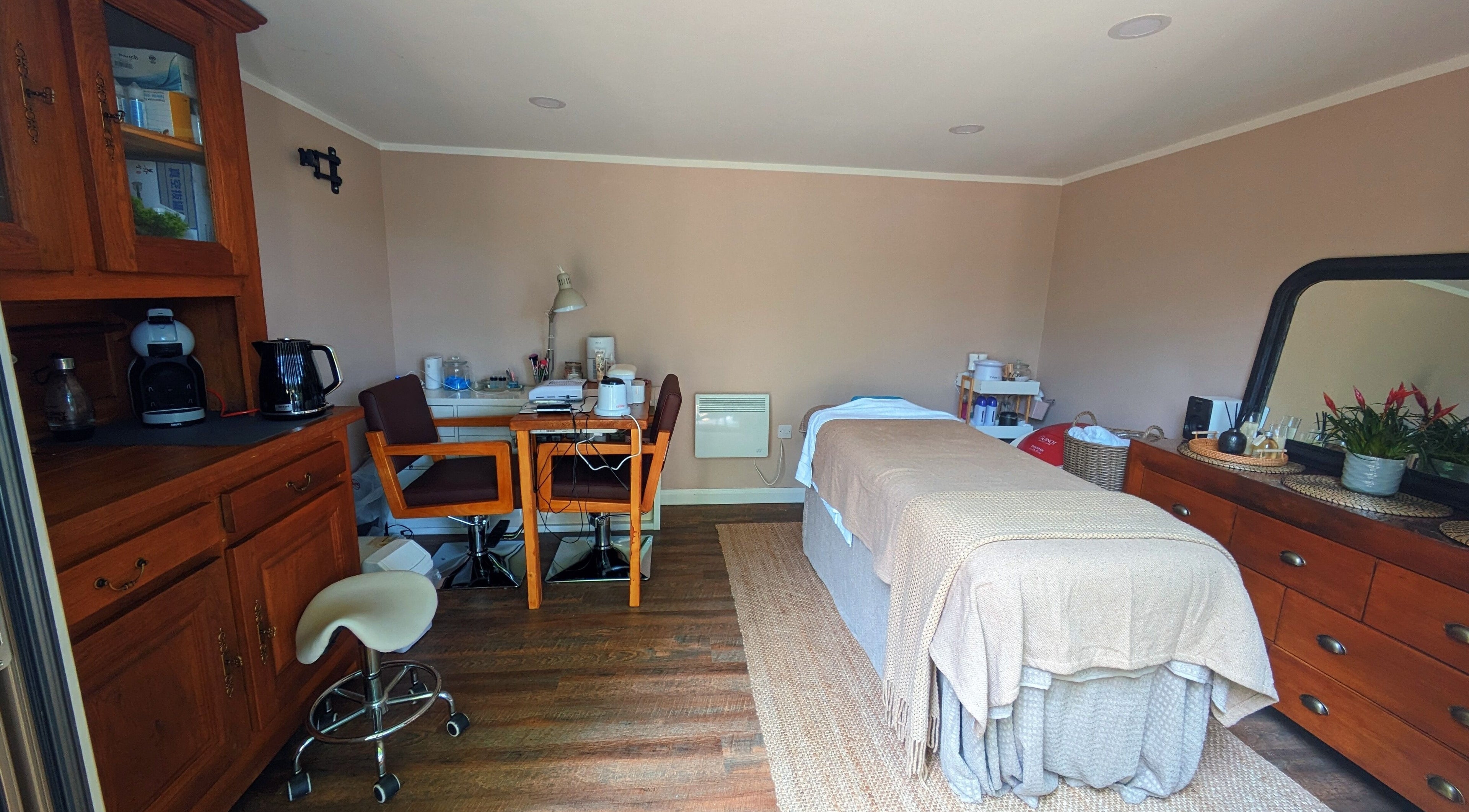 Sakura Wellness Institute's serene spa room in Audley, England, GB, featuring a massage table and calming decor.