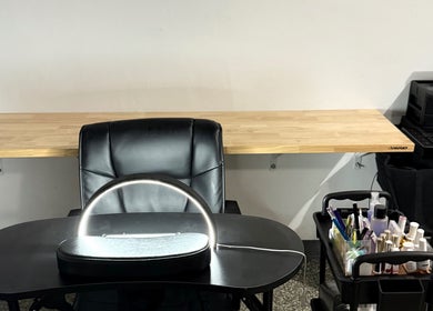 Modern nail station at Glow Studio Coral Springs, Coral Springs, Florida, US with sleek seating and nail supplies.