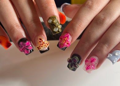 Vibrant floral nail art at ÀTÍKÉ LONDON, London, England, GB, showcasing intricate hand-painted designs.