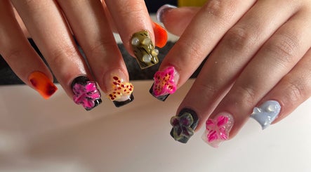 Vibrant floral nail art at ÀTÍKÉ LONDON, London, England, GB, showcasing intricate hand-painted designs.