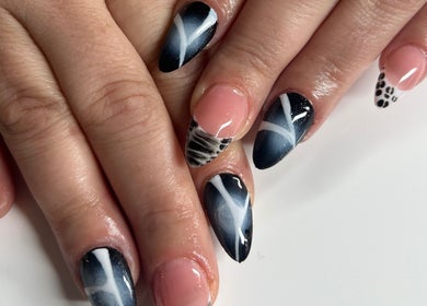 Elegant nail art at ÀTÍKÉ LONDON in London, England, GB featuring black and pink designs.