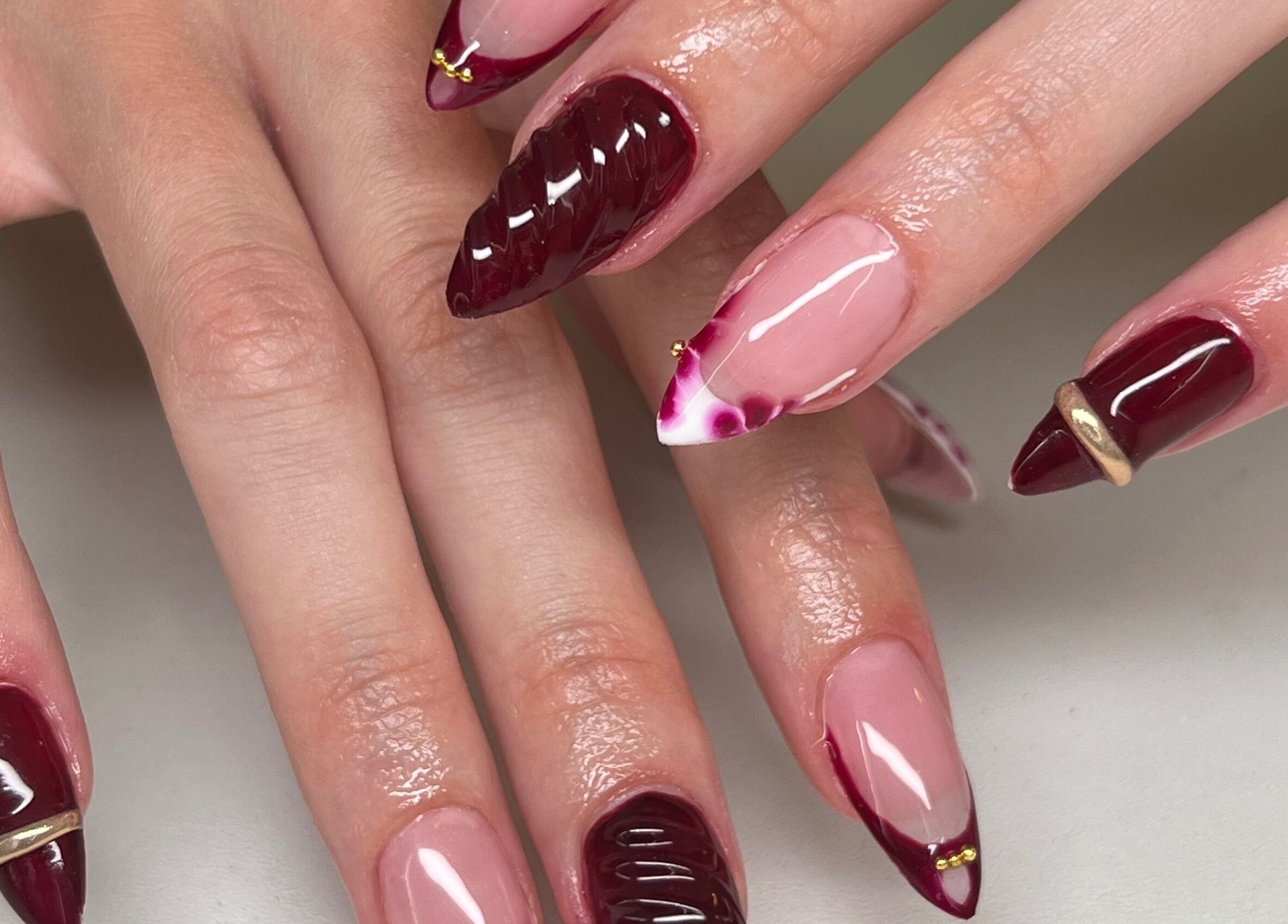 Stylish burgundy and pink nail art at ÀTÍKÉ LONDON, London, England, GB. Elegant, sophisticated design.
