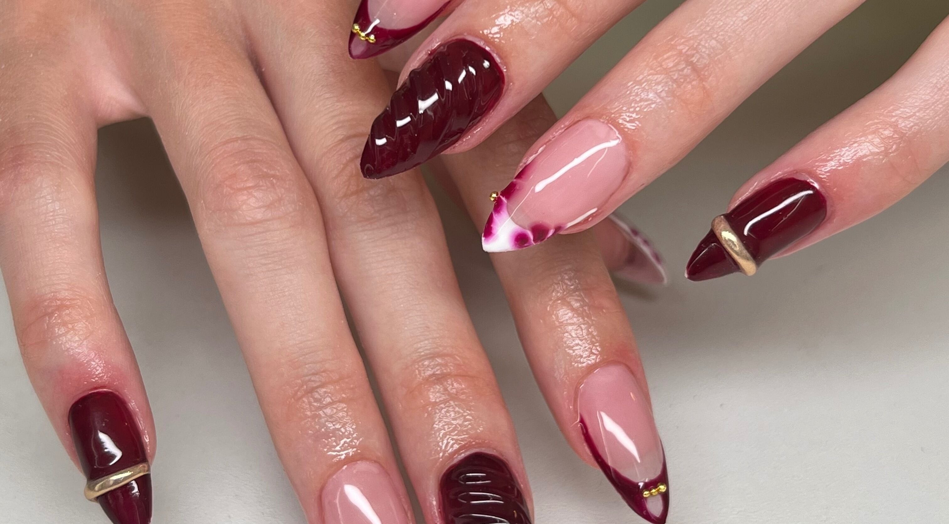 Stylish burgundy and pink nail art at ÀTÍKÉ LONDON, London, England, GB. Elegant, sophisticated design.