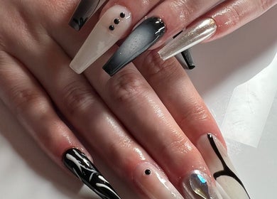Stylish black and white nail art at ÀTÍKÉ LONDON, London, England, GB, showcasing intricate designs.