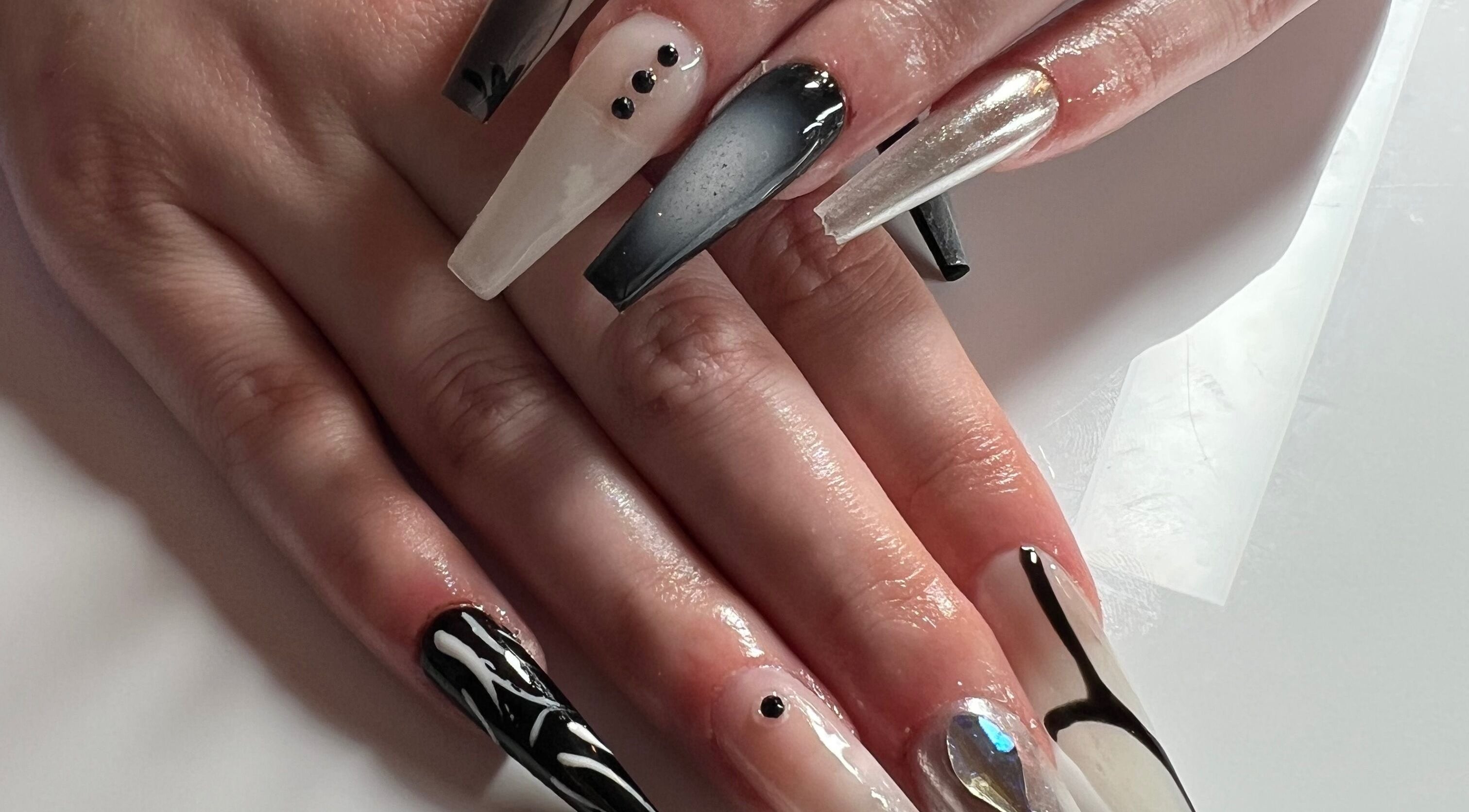 Stylish black and white nail art at ÀTÍKÉ LONDON, London, England, GB, showcasing intricate designs.