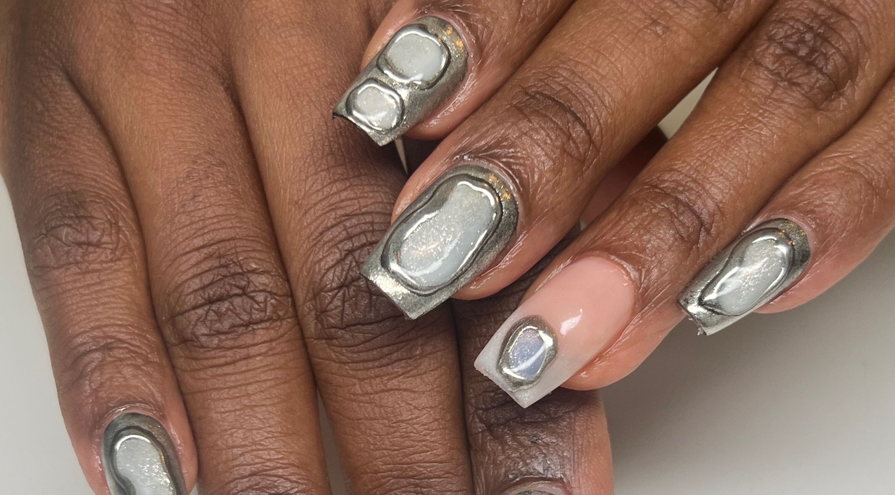 Unique chrome nail art at ÀTÍKÉ LONDON, showcasing trendy designs in London, England, GB.