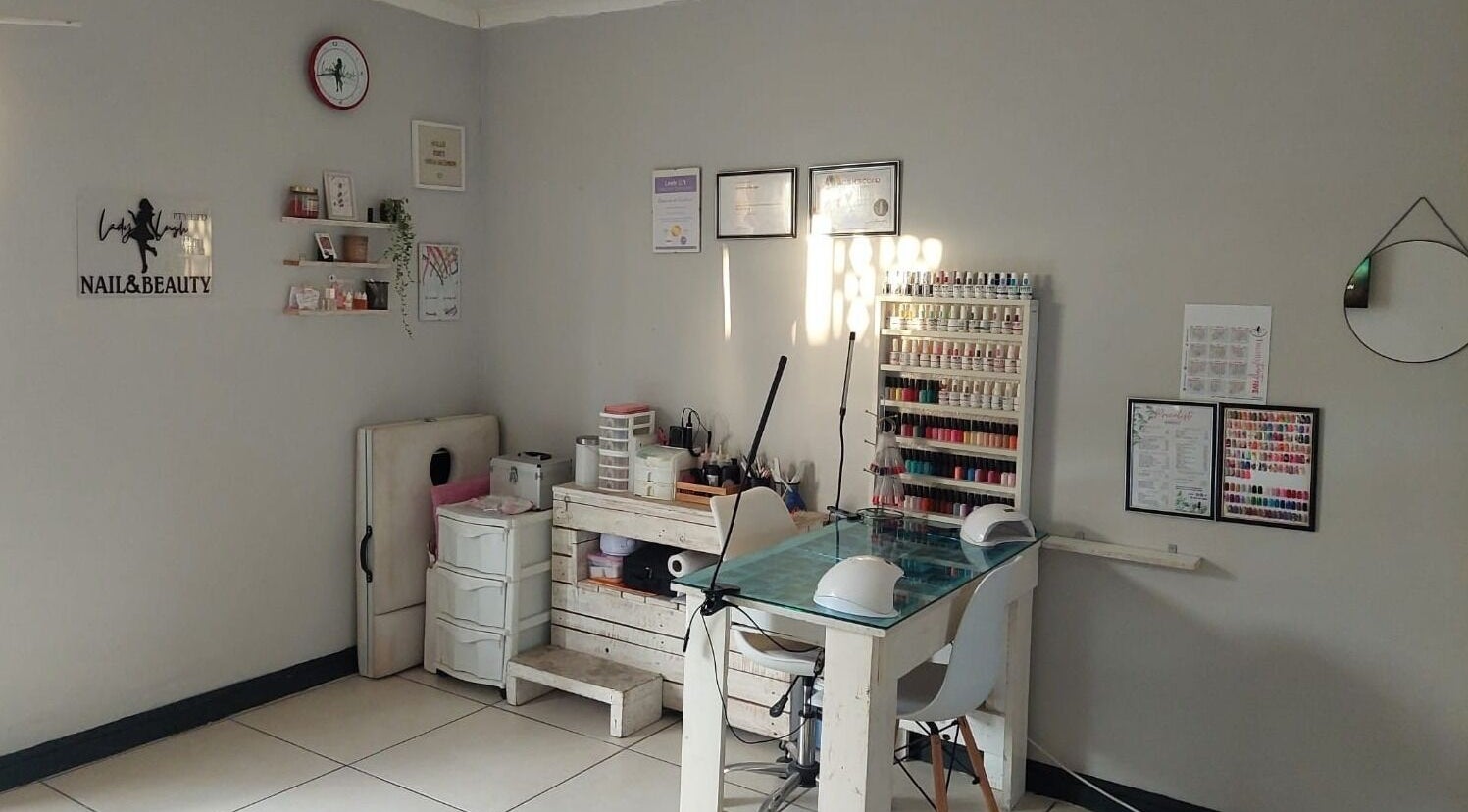 Lady Lush Nails & Beauty cozy interior in Cape Town with polish display and manicure station.