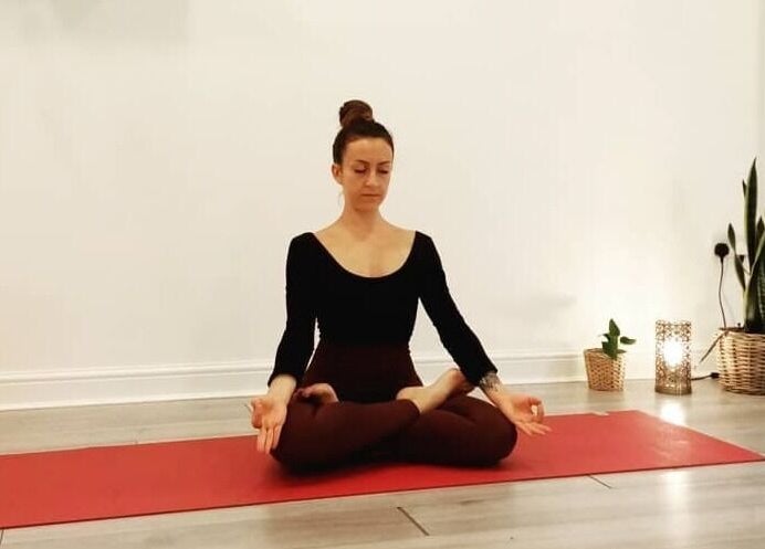 Woman meditating in yoga pose at Holistic BodyWork with Erica, Leeds, England, GB.