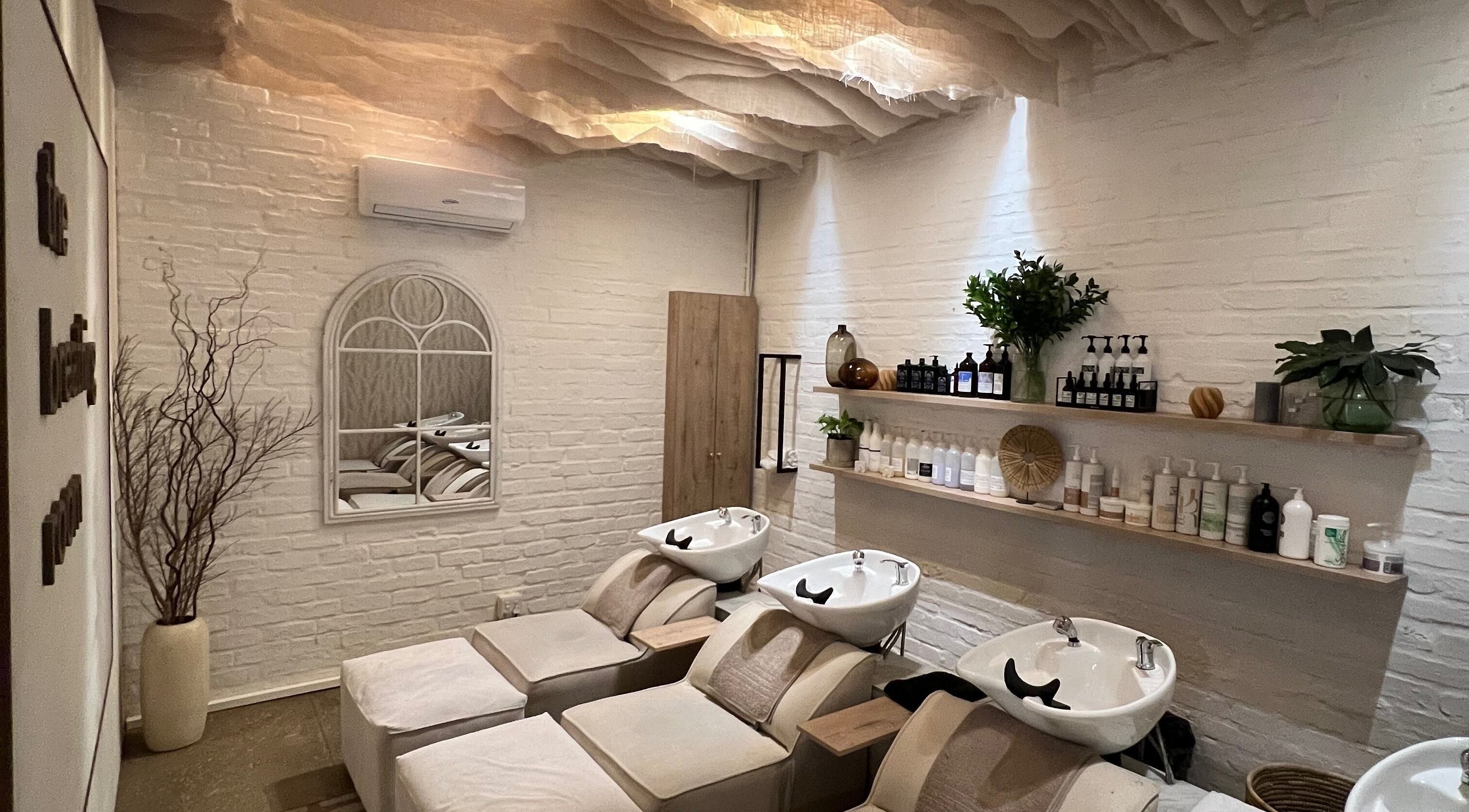 Relaxing wash area at BHAVA Hair Lounge, Gqeberha, Eastern Cape, ZA with cozy seating and stylish decor.