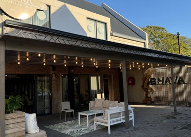 BHAVA Hair Lounge entrance with cozy seating and warm lights in Gqeberha, Eastern Cape, ZA.