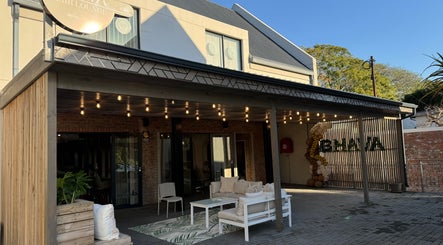 BHAVA Hair Lounge entrance with cozy seating and warm lights in Gqeberha, Eastern Cape, ZA.