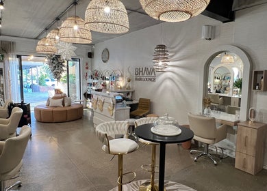 Elegant interior of BHAVA Hair Lounge, Gqeberha, Eastern Cape, ZA featuring stylish decor and salon chairs.