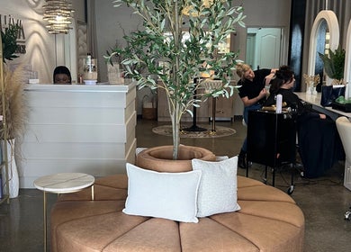 BHAVA Hair Lounge in Gqeberha, Eastern Cape, ZA showcasing elegant seating and hairstyling in a modern setting.