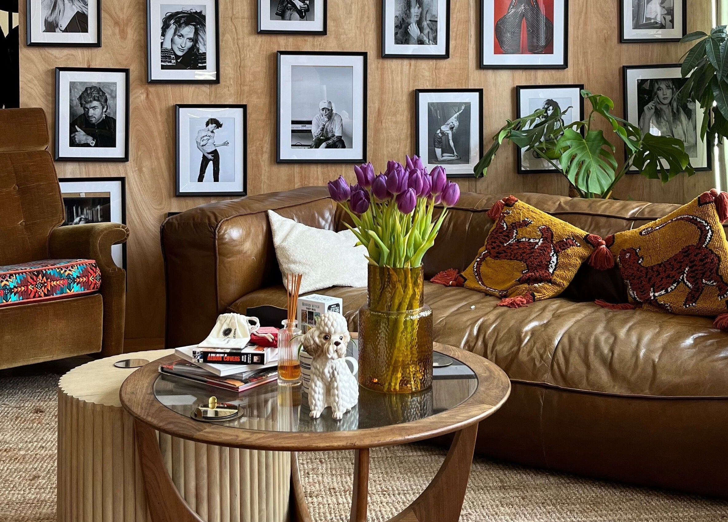 Inviting salon corner at Laura Does Hair in Leeds, England, GB with leather sofa and art-filled walls.