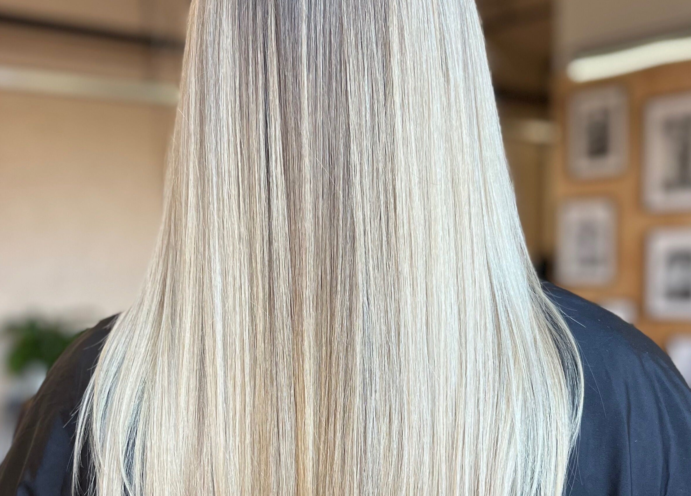 Sleek blonde hair styled at Laura Does Hair, Leeds, England, GB. Perfect for a chic, modern look.