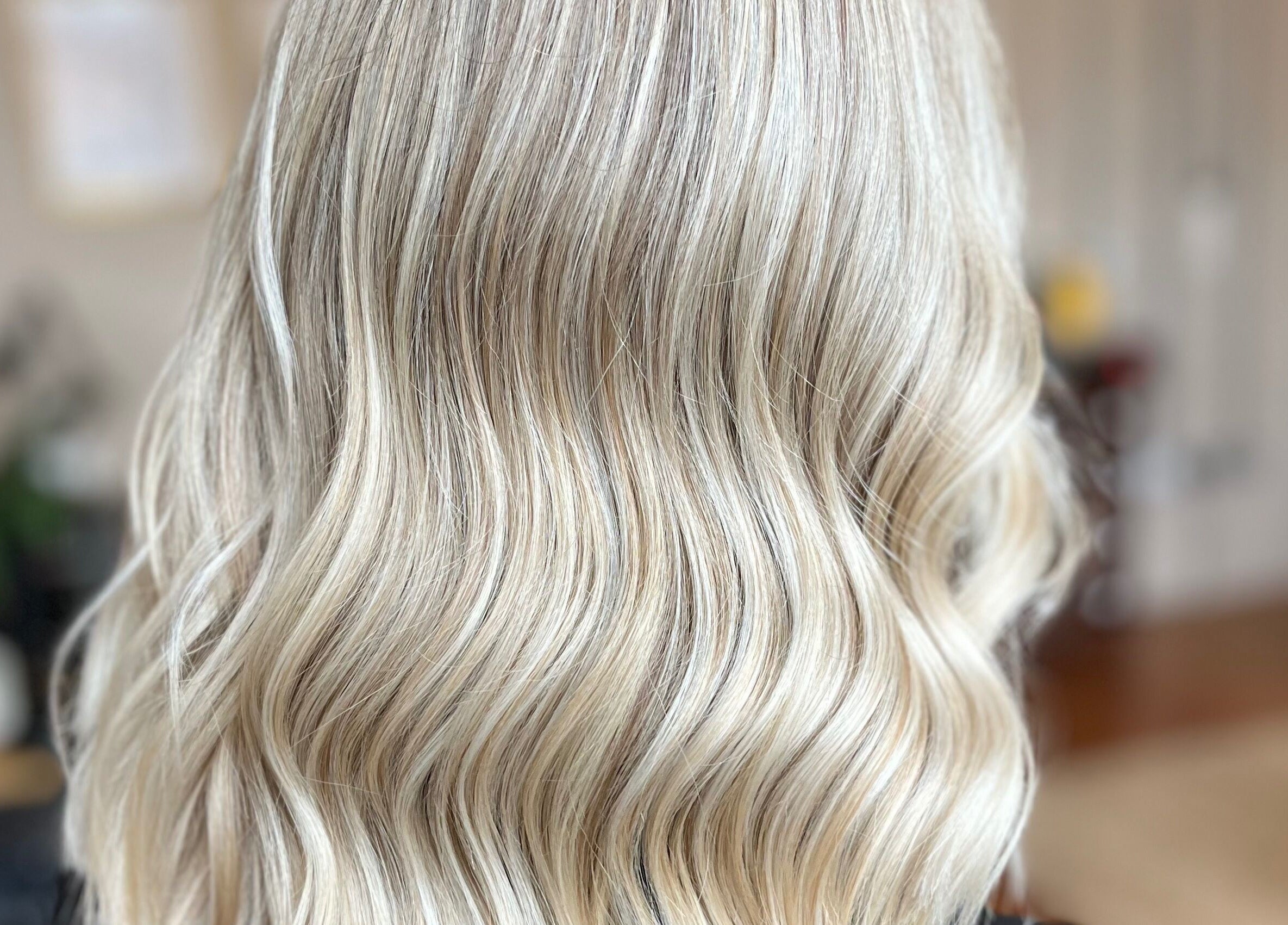 Blonde wavy hairstyle at Laura Does Hair, Leeds, England, GB. Perfect salon styling for elegant looks.