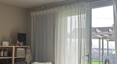 Serene interior of Ataraxy with Abby, Blantyre, Scotland, GB, featuring soft curtains and cozy decor.