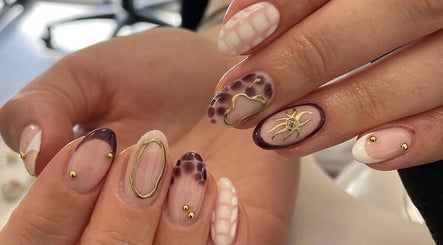 Intricate nail art with gold accents at Courtbeauty, Basildon, England, GB.