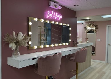 Stylish vanity at Arch Rivals Brow Studio, Port Coquitlam, BC, with pink walls and chic decor.