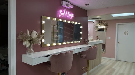 Stylish vanity at Arch Rivals Brow Studio, Port Coquitlam, BC, with pink walls and chic decor.