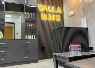 Yalla Hair Salon, Hair Replacement Centre on Sheikh Zayed Road in Dubai, sleek interior with products on display.
