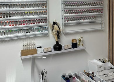 Nail polish display at Beehive By Charlotte, New Tupton, England, GB showcases vibrant colors.