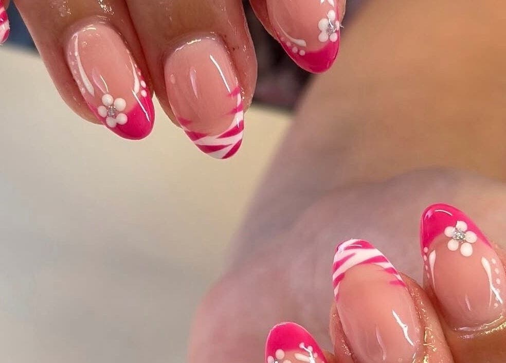 Elegant pink floral nail design at Beehive By Charlotte in New Tupton, England, GB.