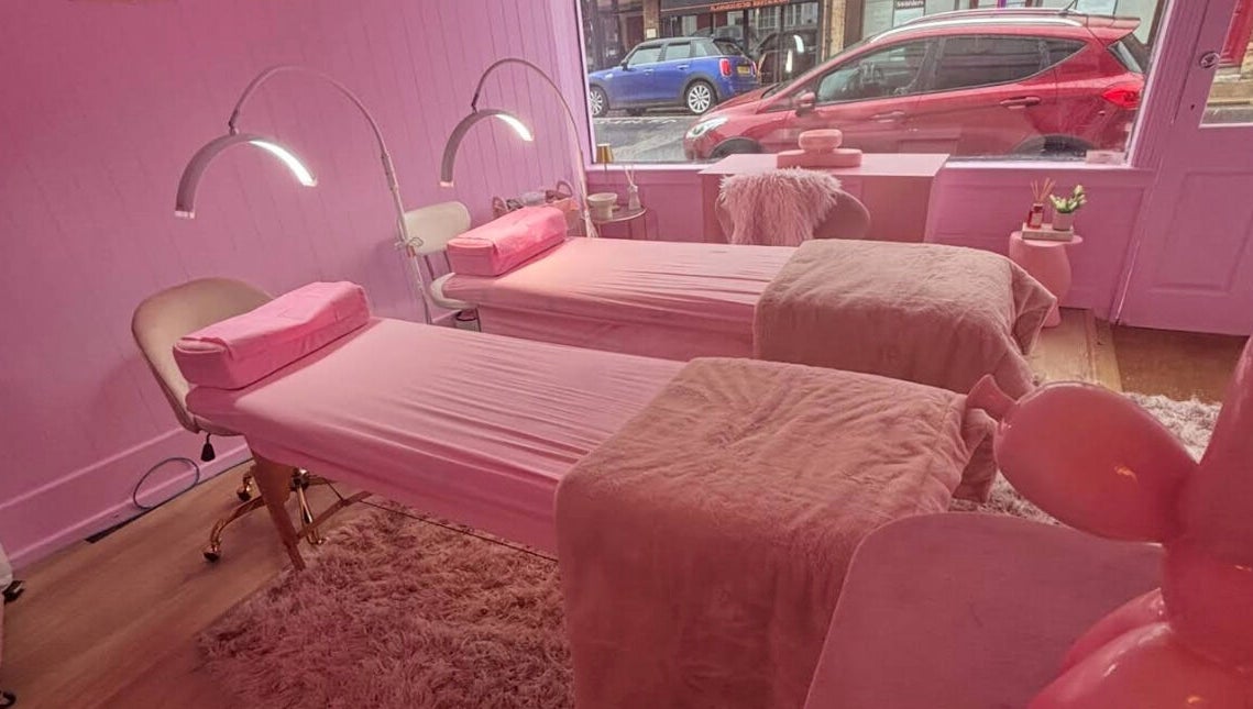 Relaxing pink interior of Lotties Lashes in Sudbury, England, GB, featuring cozy treatment beds.