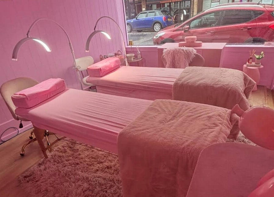 Relaxing pink interior of Lotties Lashes in Sudbury, England, GB, featuring cozy treatment beds.
