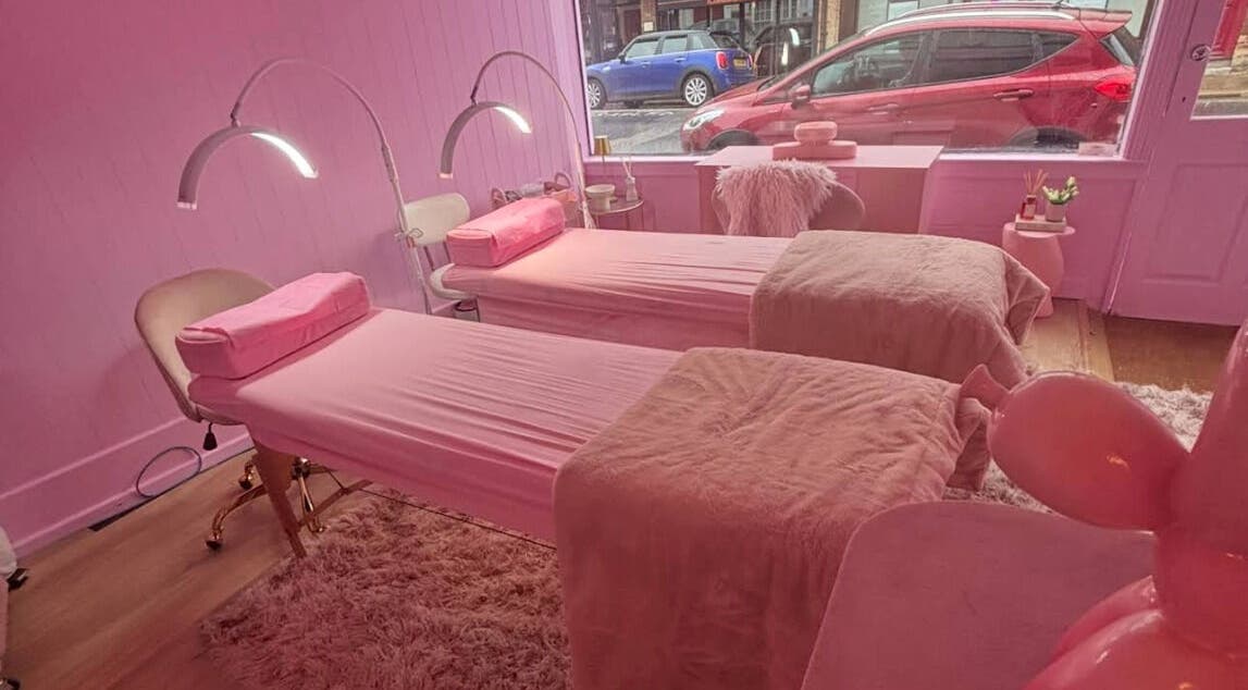 Relaxing pink interior of Lotties Lashes in Sudbury, England, GB, featuring cozy treatment beds.