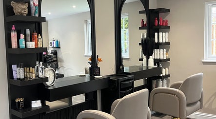 Hair by Tia's elegant salon interior in Stanway, England, GB, featuring stylish mirrors and salon chairs.