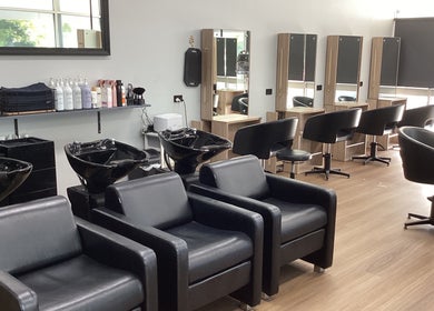 Stylish interior of Beach Hair Bribie Island salon in Banksia Beach, Queensland with modern chairs and mirrors.