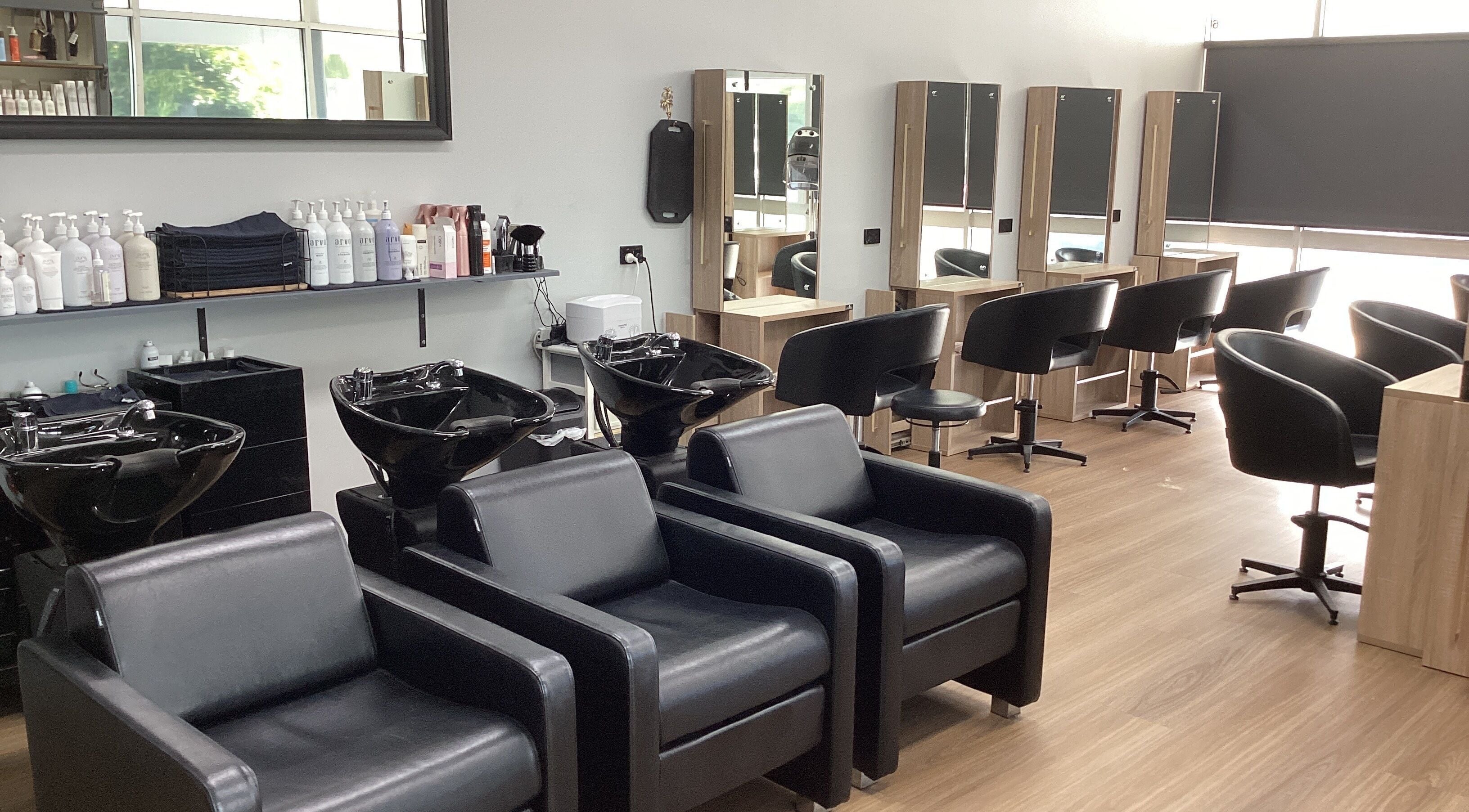Stylish interior of Beach Hair Bribie Island salon in Banksia Beach, Queensland with modern chairs and mirrors.