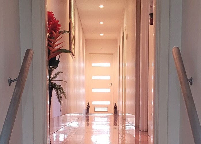 Tranquil hallway at Jindaa Thai Massage, Bendigo, Victoria, AU with soft lighting and floral decor.